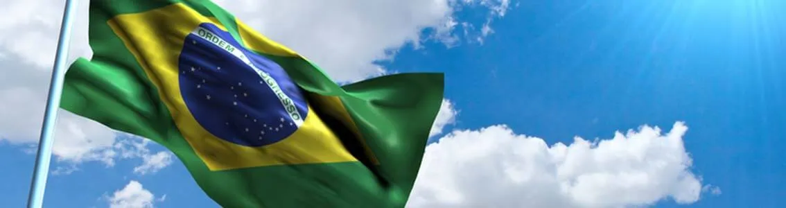 Brazilian flag in front of blue sky